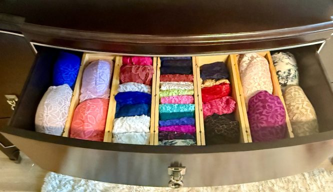 A neatly organized drawer filled with various colorful yarns and fibers.